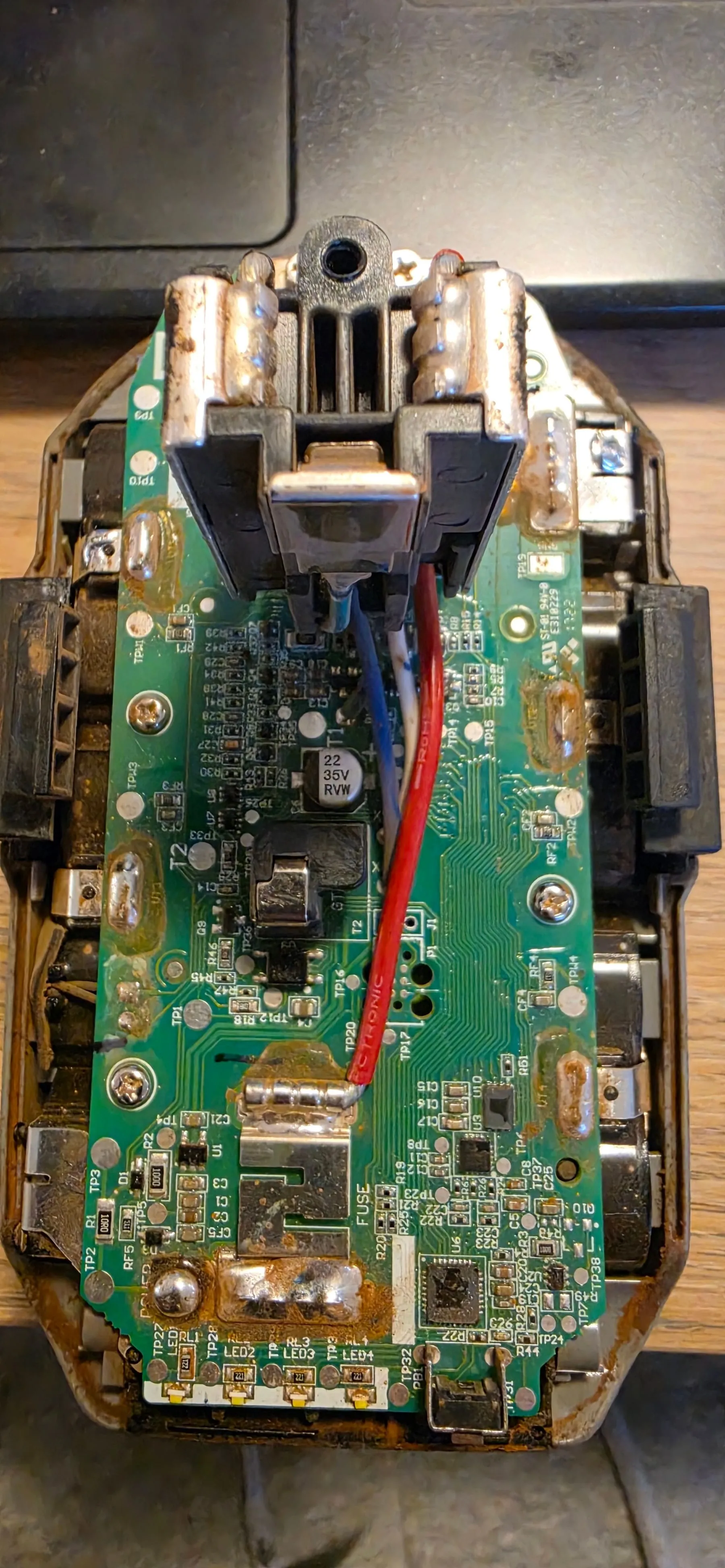 The battery management board from a Ryobi 18V ONE+ pack, out of its case, with the cell connections down each side and the LED gauge at the bottom