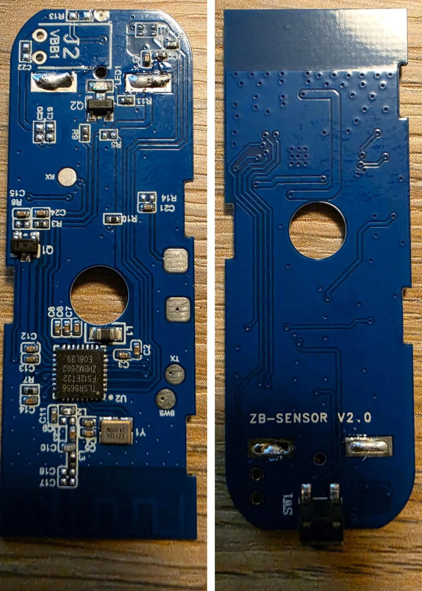 Both sides of a small blue Zigbee door sensor board marked ZB-SENSOR V2.0. The front has a TLSR8656 Zigbee chip, a crystal, battery pads at the top, and test pads marked TX, RX and SWS. The back has the pairing button.